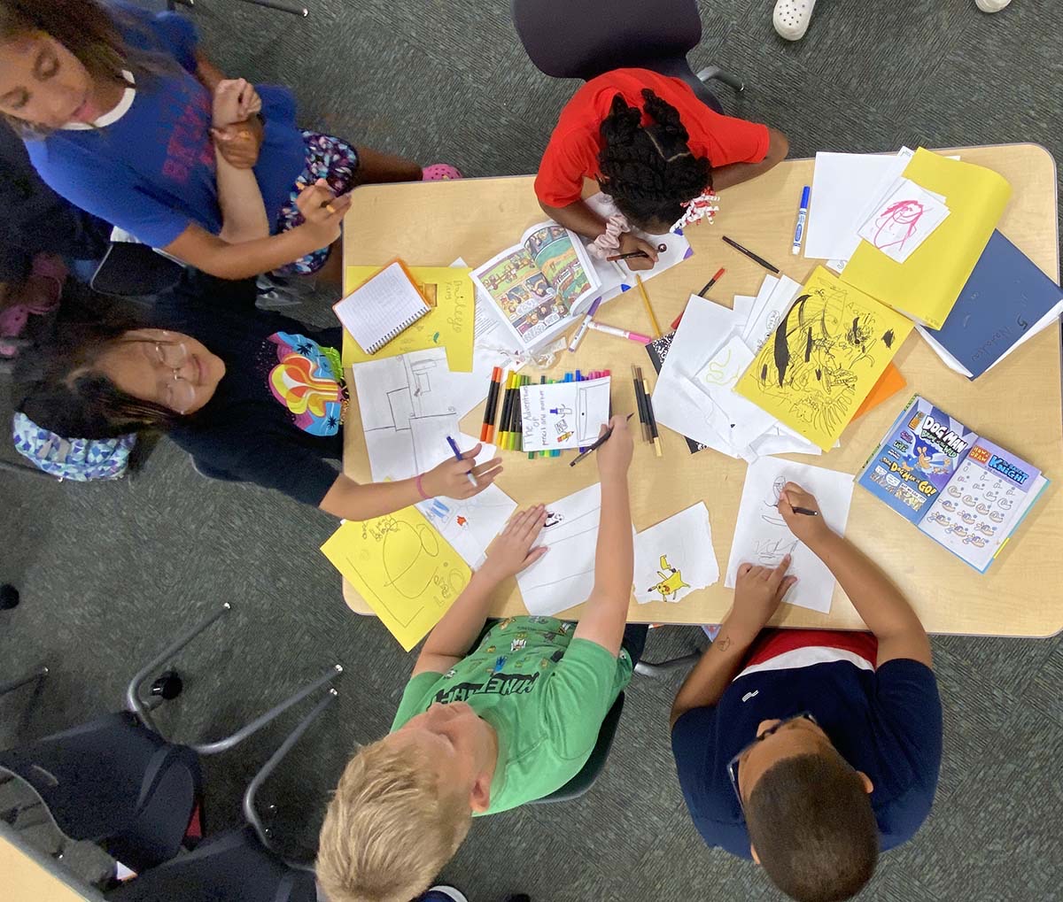 Kids drawing in a workshop led by author and illustrator Stephanie Watson.